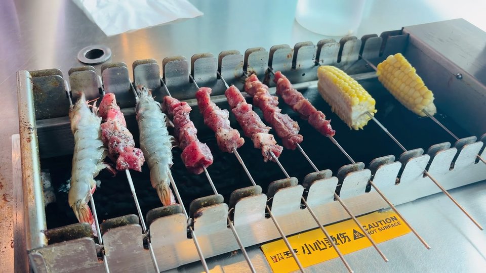 Plates of grilled food on a restaurant table.