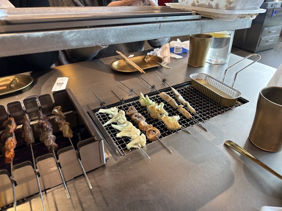 Skewers sizzling over an open grill.